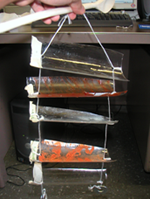 image of rectangle cuts of 2 liter soda bottles hanging on strings