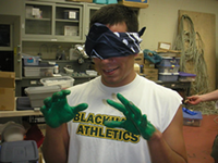 image of a blind folded scientist with gloves on
