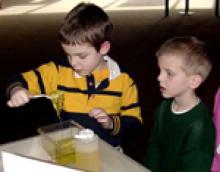 young children playing with gummi-worms
