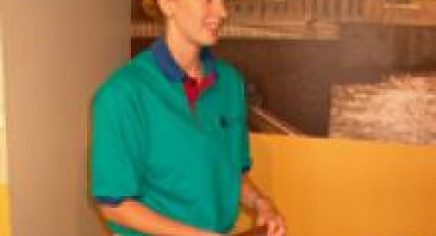 Person standing holding a paper